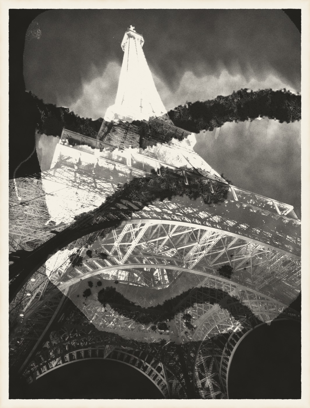 A chemigram on a print of the Eiffel Tower: bleach run around brushed wax, developer spatter, the wax peeled away