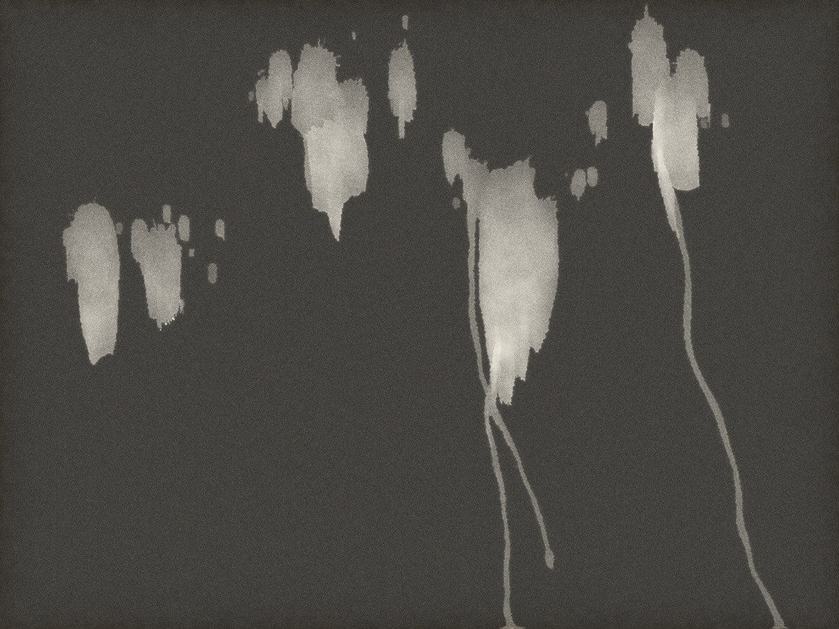 Bleach drops sliding down a tipped print into comet trails
